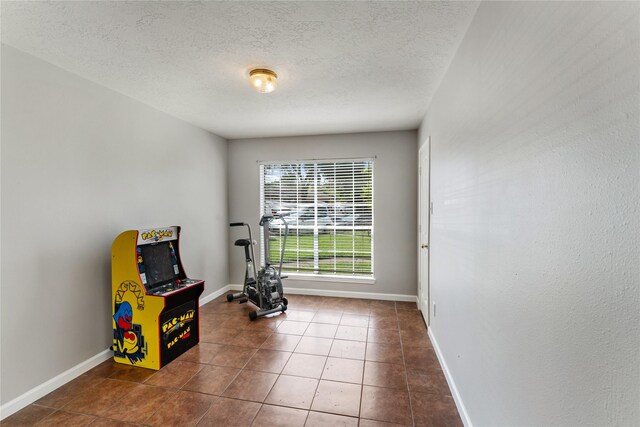 2410 Prides Crossing Rd, Houston, TX 77067 - rec room with tile patterned flooring and a textured ceiling
