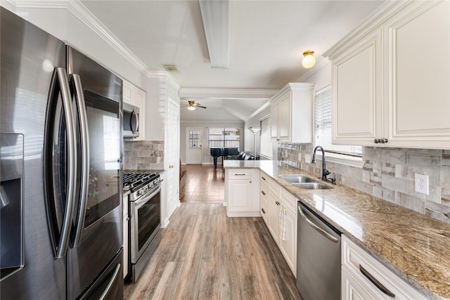 2410 Prides Crossing Rd, Houston, TX 77067 - kitchen with stainless steel appliances, open floor plan, decorative backsplash, light stone countertops, and light wood-style floors