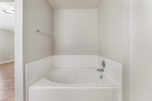 2410 Prides Crossing Rd, Houston, TX 77067 - bathroom with a jetted tub and a textured ceiling