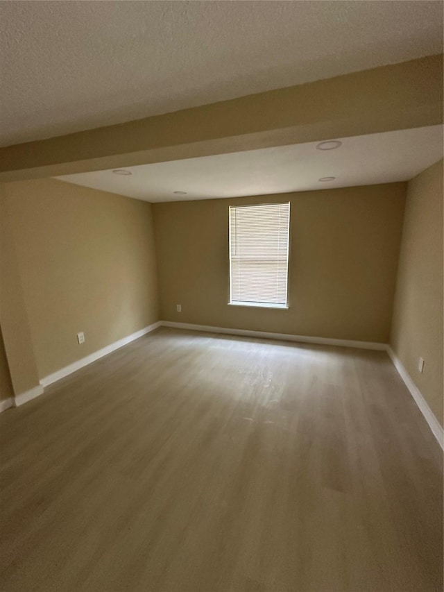 607 E Miller St, Angleton, TX 77515 - empty room featuring wood finished floors and a textured ceiling