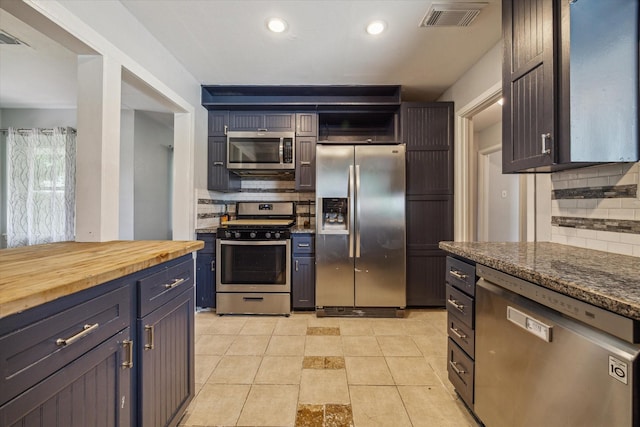 4606 Nina Lee Ln, Houston, TX 77092 - kitchen with stainless steel appliances, decorative backsplash, open shelves, recessed lighting, and butcher block countertops