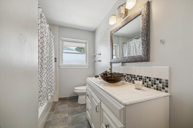 4606 Nina Lee Ln, Houston, TX 77092 - full bathroom featuring backsplash, vanity, stone finish floors, and shower / bathtub combination with curtain