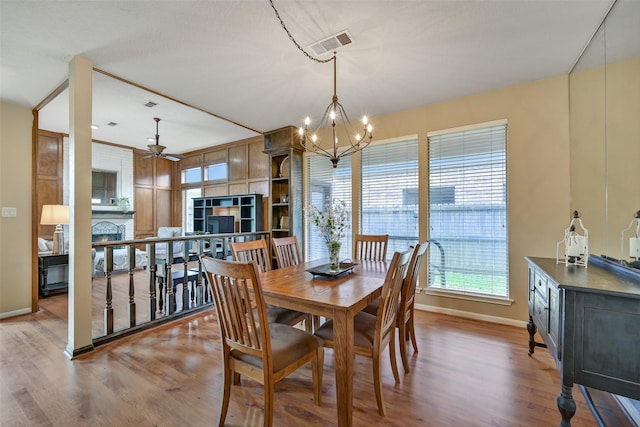 2706 Country Club Dr, Pearland, TX 77581 - dining space with wood finished floors, a ceiling fan, and a chandelier