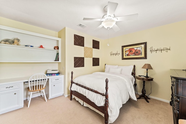 115 Heather Ln, Conroe, TX 77385 - bedroom with built in desk, light colored carpet, and ceiling fan