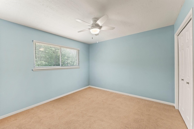 115 Heather Ln, Conroe, TX 77385 - unfurnished bedroom with a closet, carpet, and a ceiling fan