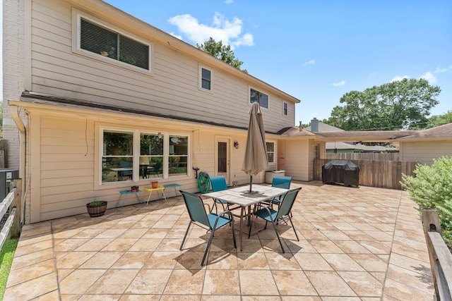 115 Heather Ln, Conroe, TX 77385 - rear view of property featuring a patio area and outdoor dining area