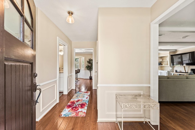 115 Heather Ln, Conroe, TX 77385 - entryway with wood finished floors and a wainscoted wall