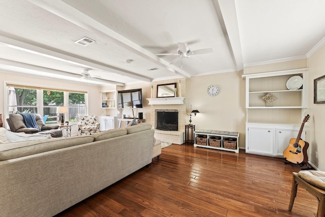 115 Heather Ln, Conroe, TX 77385 - living room featuring ceiling fan, wood-type flooring, beamed ceiling, a fireplace, and crown molding