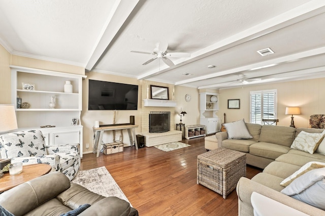 115 Heather Ln, Conroe, TX 77385 - living room featuring ceiling fan, beamed ceiling, wood finished floors, and ornamental molding