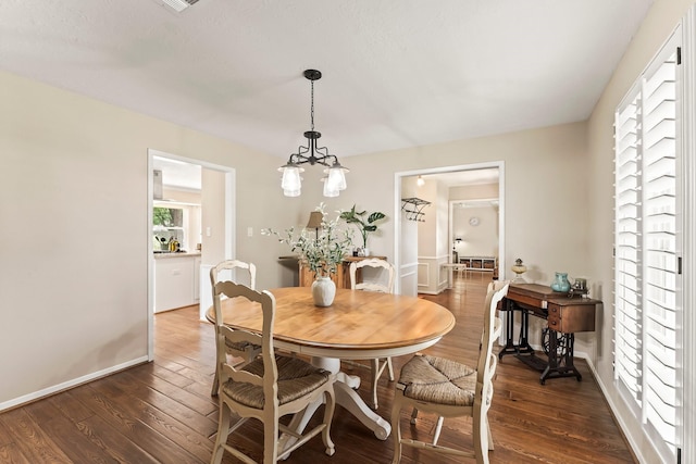 115 Heather Ln, Conroe, TX 77385 - dining area featuring dark wood-style flooring and a chandelier
