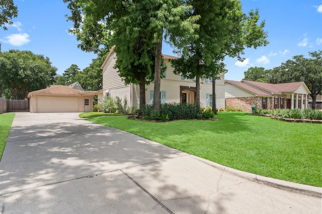 115 Heather Ln, Conroe, TX 77385 - view of front of house with a front lawn, driveway, an attached garage, and brick siding