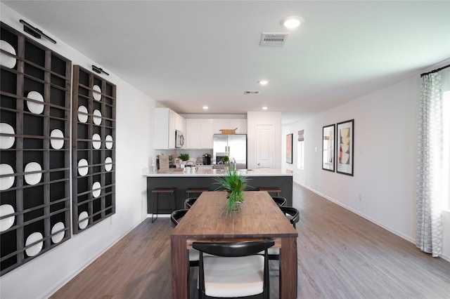 10808 Red Orchid Dr, Houston, TX 77016 - dining area featuring dark wood-style floors and recessed lighting