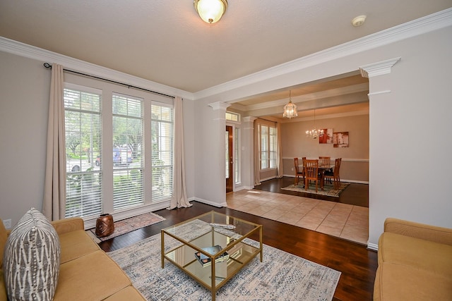 806 Spring Mist Ct, Sugar Land, TX 77479 - living area with ornamental molding, a chandelier, wood finished floors, and ornate columns