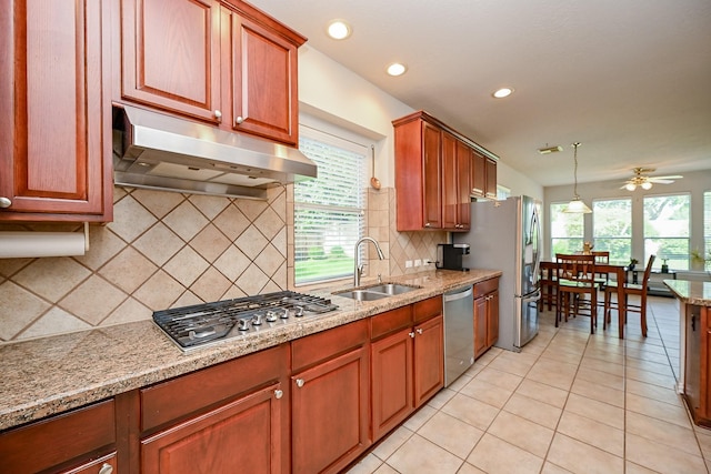 806 Spring Mist Ct, Sugar Land, TX 77479 - kitchen featuring stainless steel appliances, under cabinet range hood, ceiling fan, backsplash, and light stone countertops