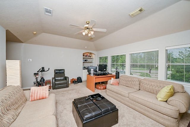 806 Spring Mist Ct, Sugar Land, TX 77479 - carpeted living room featuring a ceiling fan, a desk, vaulted ceiling, built in shelves, and a textured ceiling