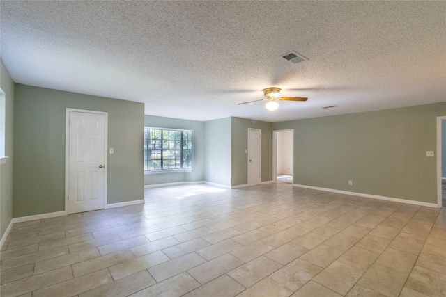 15823 Stagecoach Rd, Stagecoach, TX 77355 - unfurnished room featuring a ceiling fan, a textured ceiling, and light tile patterned floors