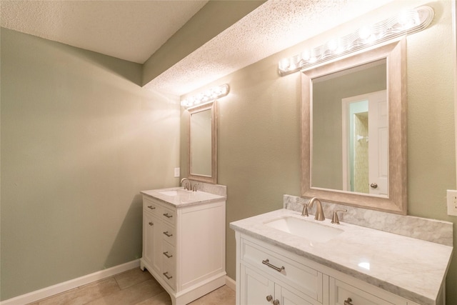 15823 Stagecoach Rd, Stagecoach, TX 77355 - full bathroom with two vanities, tile patterned floors, and a textured ceiling