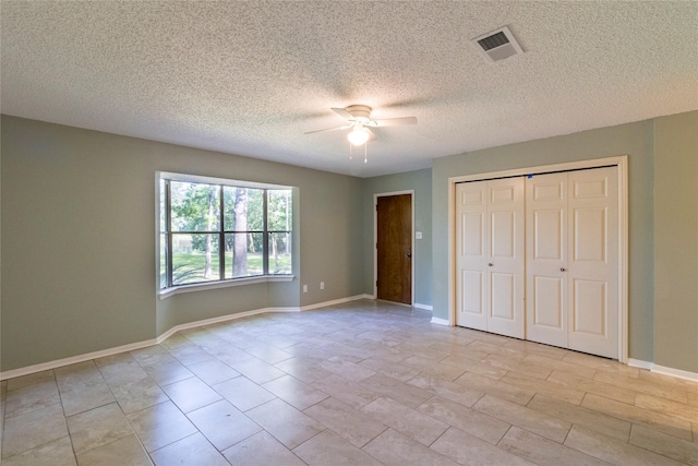 15823 Stagecoach Rd, Stagecoach, TX 77355 - unfurnished bedroom featuring a closet, ceiling fan, and a textured ceiling