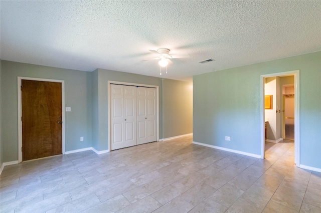 15823 Stagecoach Rd, Stagecoach, TX 77355 - unfurnished bedroom with a closet, a textured ceiling, ceiling fan, and ensuite bath