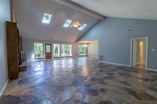 15823 Stagecoach Rd, Stagecoach, TX 77355 - unfurnished living room featuring stone floors, high vaulted ceiling, a skylight, a chandelier, and a ceiling fan