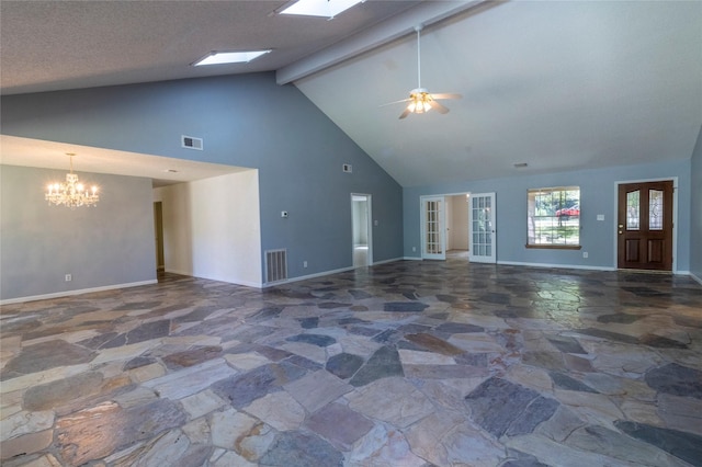 15823 Stagecoach Rd, Stagecoach, TX 77355 - unfurnished living room with stone flooring, high vaulted ceiling, a chandelier, ceiling fan, and beamed ceiling