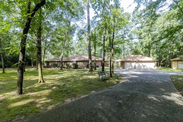 15823 Stagecoach Rd, Stagecoach, TX 77355 - single story home featuring a garage, a front lawn, and an outdoor structure