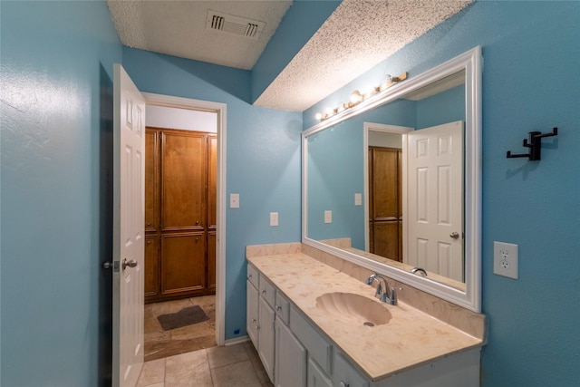 15823 Stagecoach Rd, Stagecoach, TX 77355 - bathroom with vanity, a textured ceiling, and tile patterned floors