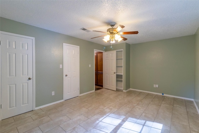 15823 Stagecoach Rd, Stagecoach, TX 77355 - unfurnished bedroom featuring a textured ceiling and a ceiling fan