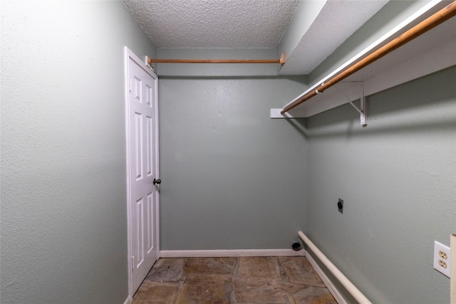 15823 Stagecoach Rd, Stagecoach, TX 77355 - washroom with electric dryer hookup and a textured ceiling