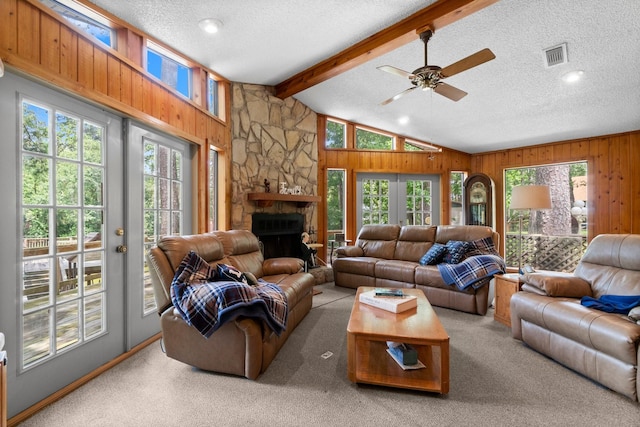 31 N Lakeview Dr, Point Blank, TX 77364 - living area with plenty of natural light, a textured ceiling, wooden walls, ceiling fan, and a stone fireplace