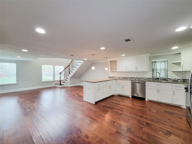 2608 Arlington St, Houston, TX 77008 - kitchen featuring stainless steel dishwasher, a peninsula, open floor plan, backsplash, and white cabinets