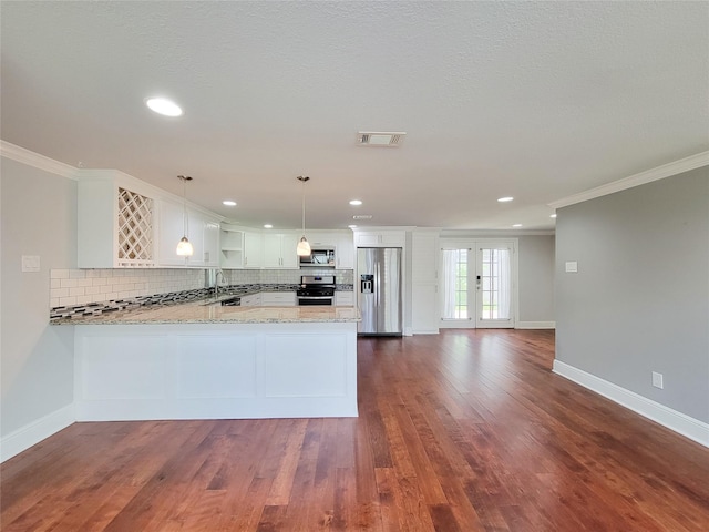 2608 Arlington St, Houston, TX 77008 - kitchen with stainless steel appliances, crown molding, backsplash, a peninsula, and light stone countertops