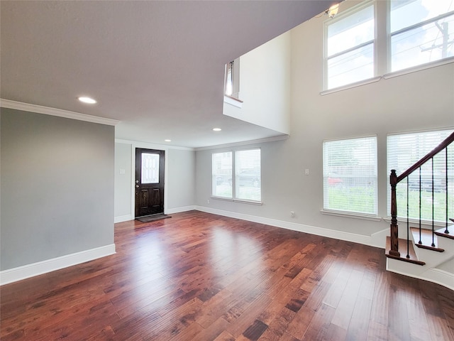 2608 Arlington St, Houston, TX 77008 - unfurnished living room featuring stairway, crown molding, plenty of natural light, dark wood finished floors, and recessed lighting