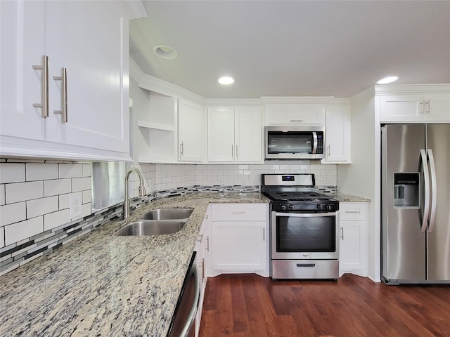 2608 Arlington St, Houston, TX 77008 - kitchen featuring stainless steel appliances, open shelves, dark wood-style floors, white cabinetry, and light stone counters