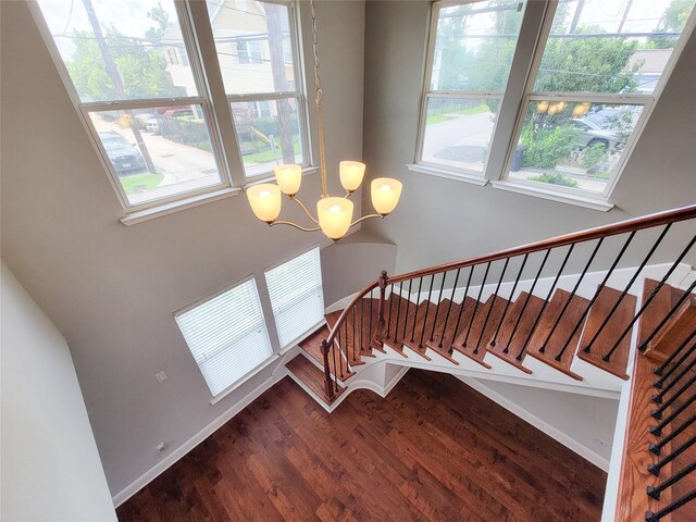 2608 Arlington St, Houston, TX 77008 - staircase featuring wood finished floors and a chandelier