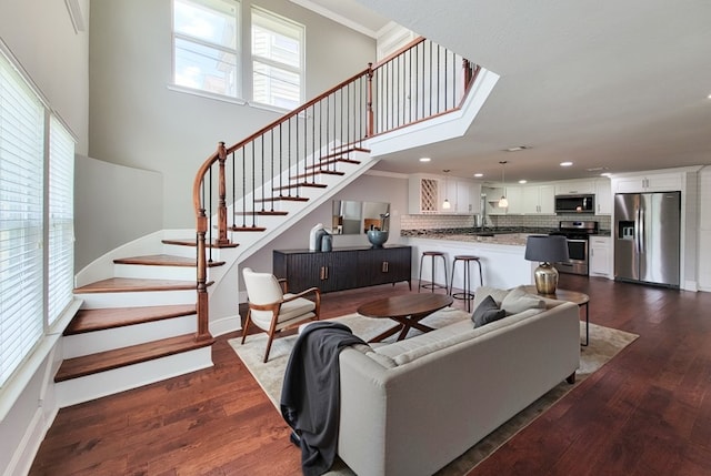 2608 Arlington St, Houston, TX 77008 - living room featuring stairs, dark wood-style flooring, recessed lighting, a towering ceiling, and crown molding