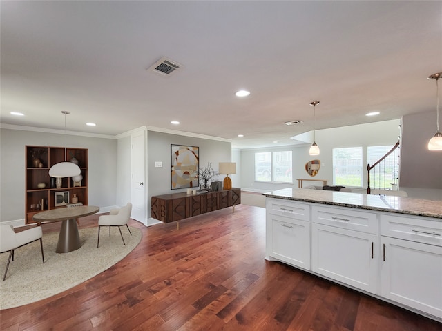 2608 Arlington St, Houston, TX 77008 - kitchen featuring recessed lighting, crown molding, white cabinetry, light stone counters, and dark wood-style floors