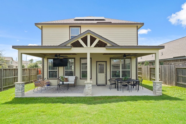 18402 Hilltop Climb Dr, Hockley, TX 77447 - back of house with a ceiling fan, solar panels, a fenced backyard, and a patio