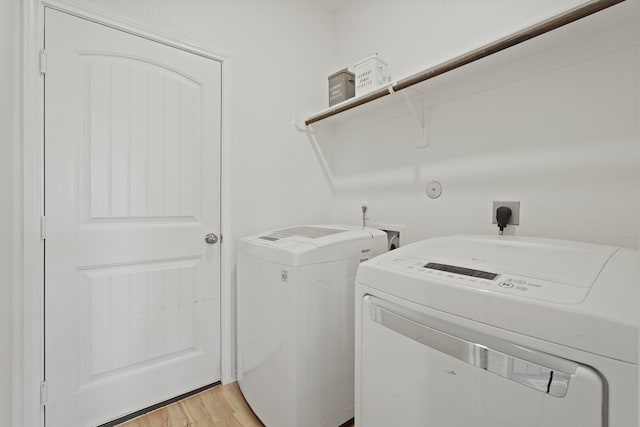 18402 Hilltop Climb Dr, Hockley, TX 77447 - laundry room featuring washing machine and dryer and light wood-style flooring