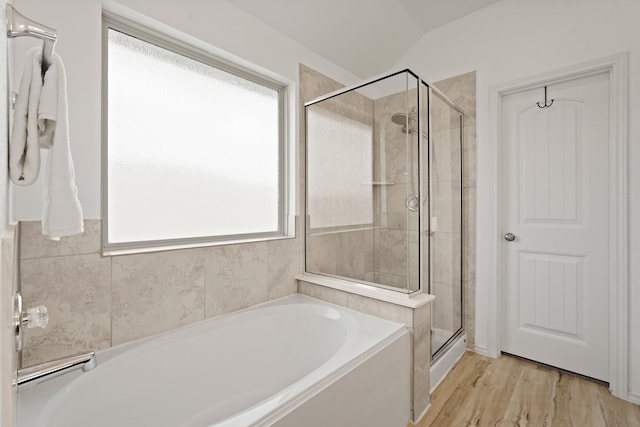 18402 Hilltop Climb Dr, Hockley, TX 77447 - bathroom featuring a garden tub, a stall shower, vaulted ceiling, and wood finished floors