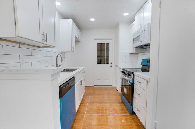 7535 Roaring Springs Dr, Houston, TX 77064 - kitchen with white microwave, electric stove, dishwashing machine, tasteful backsplash, and light countertops