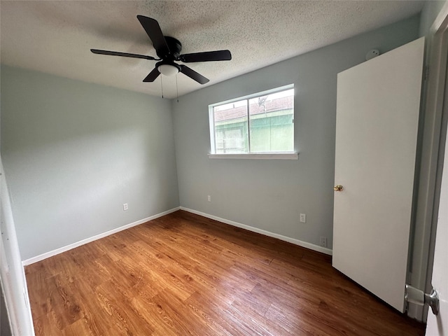 607 Reed Ave, Wharton, TX 77488 - unfurnished room with wood finished floors, ceiling fan, and a textured ceiling