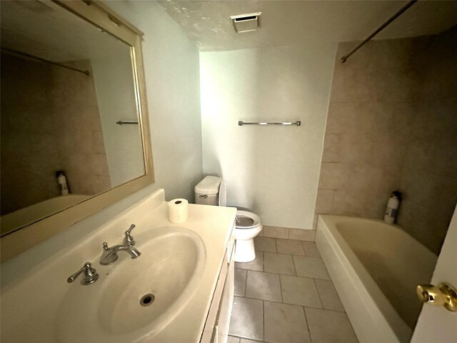 607 Reed Ave, Wharton, TX 77488 - full bath with tile patterned floors, vanity, and washtub / shower combination