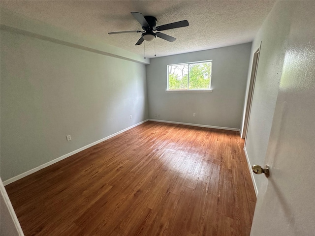 607 Reed Ave, Wharton, TX 77488 - spare room with wood finished floors, a textured ceiling, and ceiling fan