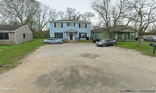 607 Reed Ave, Wharton, TX 77488 - view of front of property featuring uncovered parking, a front yard, and a porch