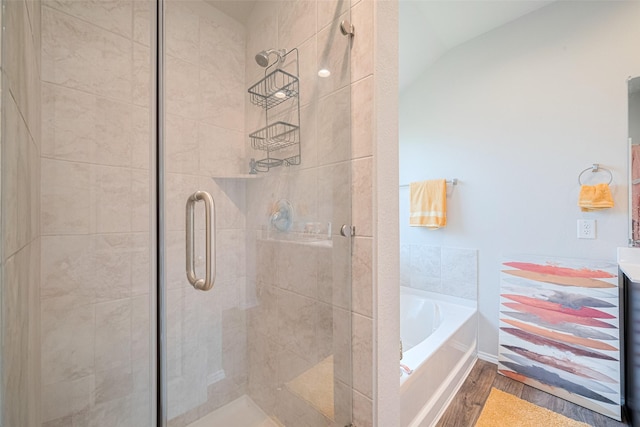 4315 Isoletta Ct, Katy, TX 77449 - bathroom featuring wood finished floors, a shower stall, a bath, and lofted ceiling