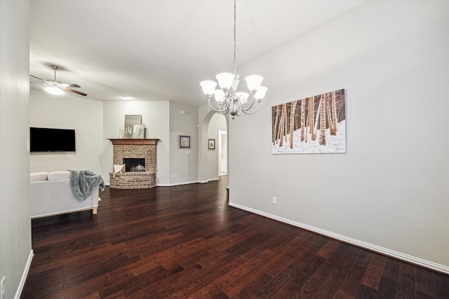 3030 Rabbit Brush Ln, Manvel, TX 77578 - living area with arched walkways, dark wood-style flooring, ceiling fan, and a chandelier