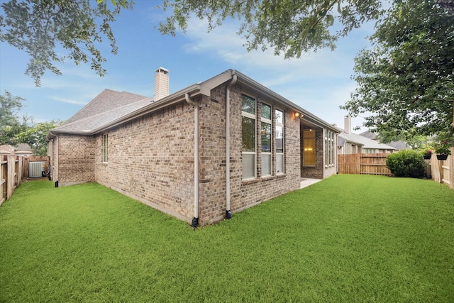 3030 Rabbit Brush Ln, Manvel, TX 77578 - view of side of home with a chimney, a fenced backyard, and brick siding