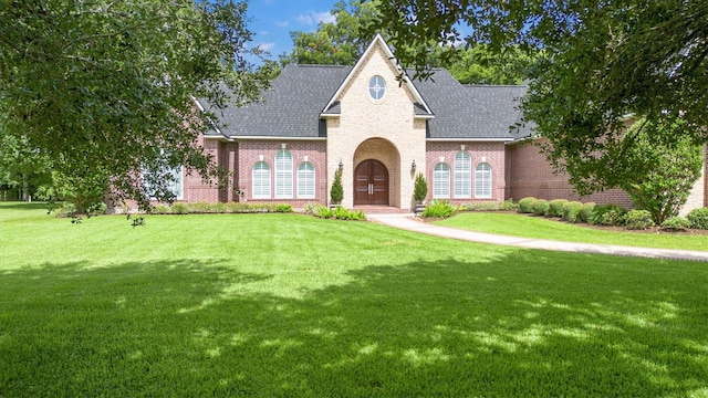 3610 Pembrooke Dr, Richmond, TX 77406 - view of front of home featuring brick siding, a shingled roof, and a front lawn