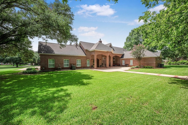 3610 Pembrooke Dr, Richmond, TX 77406 - view of front of property with a front yard, brick siding, a chimney, and a shingled roof